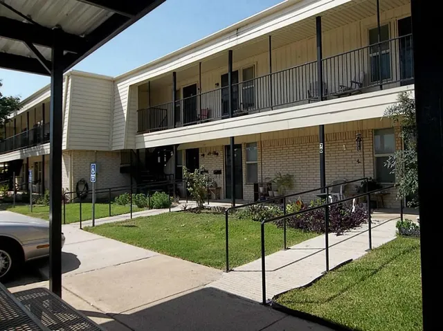 a view of a house with backyard porch and sitting area