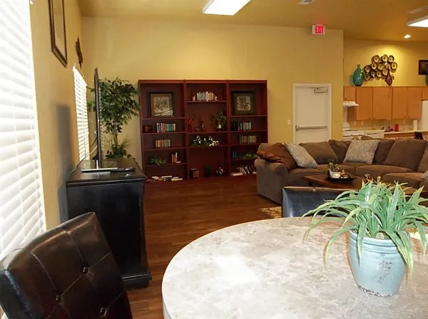 a living room with furniture and painting on the wall