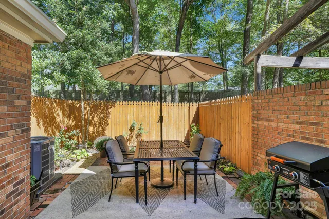 a view of an outdoor sitting area with furniture and umbrella