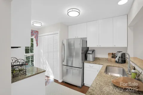 a kitchen with a sink a refrigerator and a stove