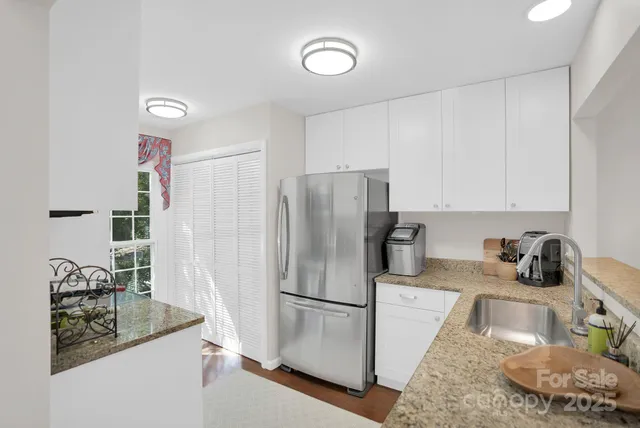 a kitchen with a sink a refrigerator and a stove