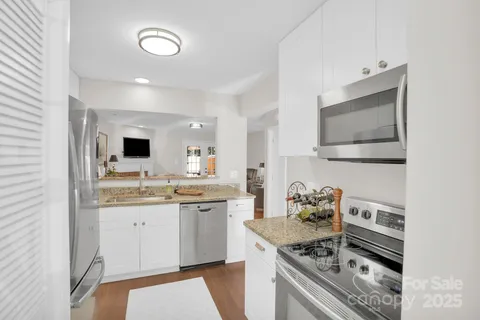 a kitchen with a sink stove and cabinets