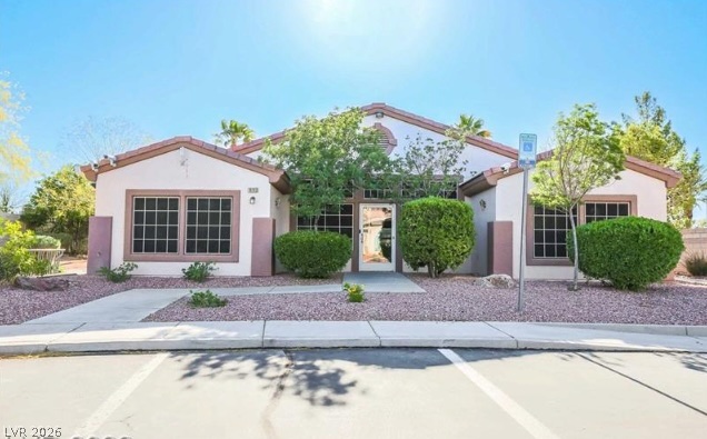 10247 Rising Tree Street Las Vegas, NV 89183 - Photo 4 of 7 A well-maintained facade with neat landscaping and inviting entry.