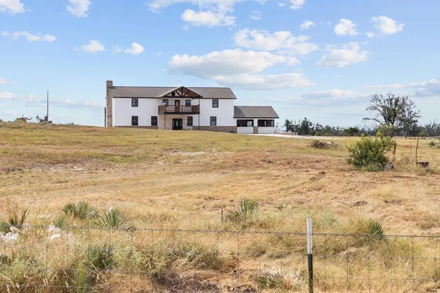 a very nice looking house with a big yard