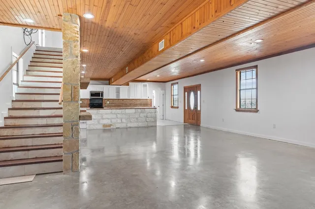 a kitchen with refrigerator and cabinets