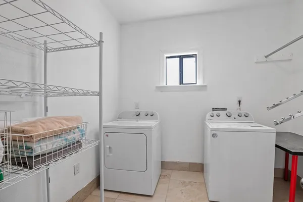 a bathroom with a toilet sink vanity and shower