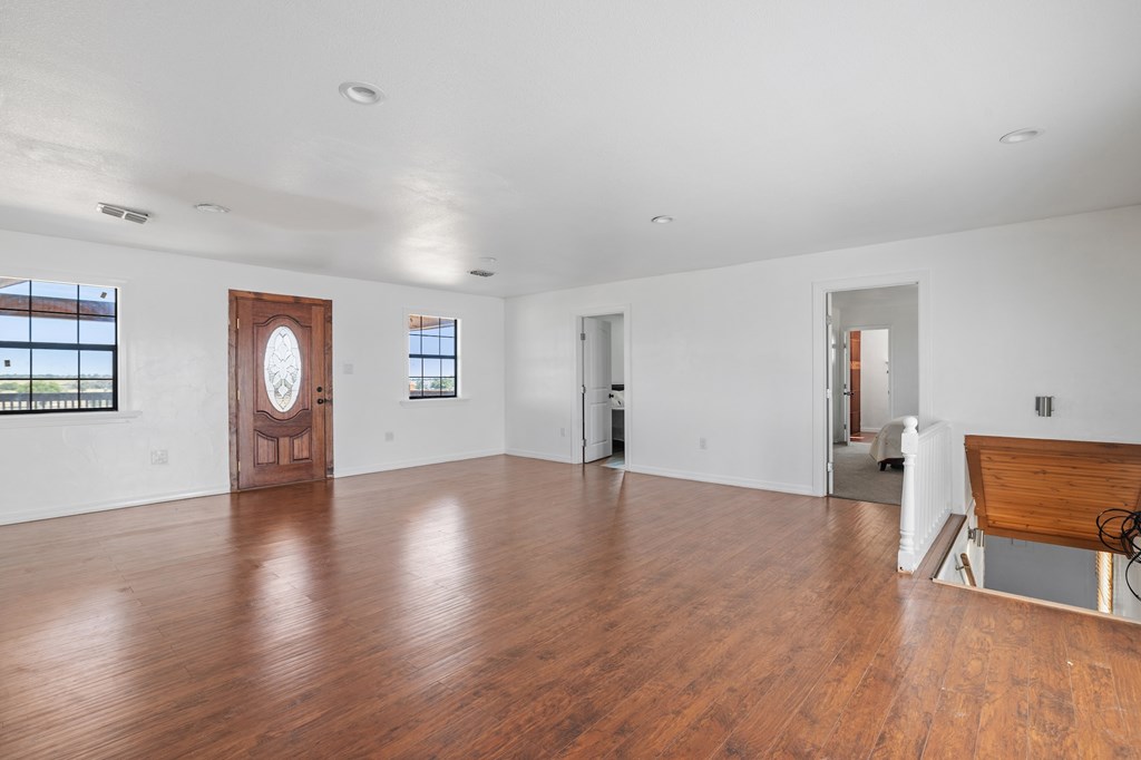 288.000000 Kroll Road Harper, TX 78631 - Photo 21 of 49 a view of an empty room with wooden floor and a window