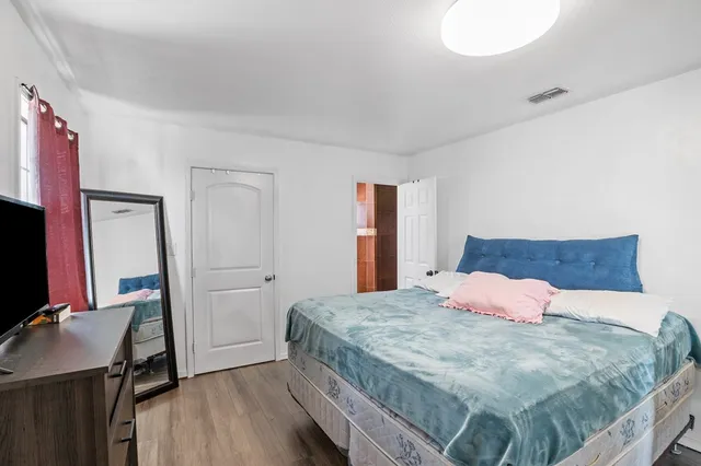 a bedroom with a bed and lamp