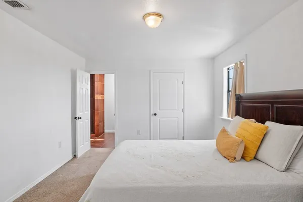 a bedroom with a bed and a couch