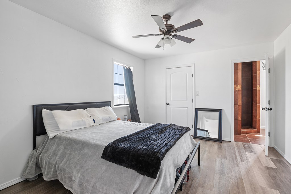 288.000000 Kroll Road Harper, TX 78631 - Photo 32 of 49 a bedroom with a large bed and a chandelier