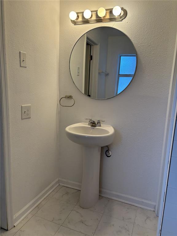 9030 Blind Pass Road, Unit C7 St. Petersburg, FL 33706 - Photo 13 of 16 a bathroom with a sink and mirror