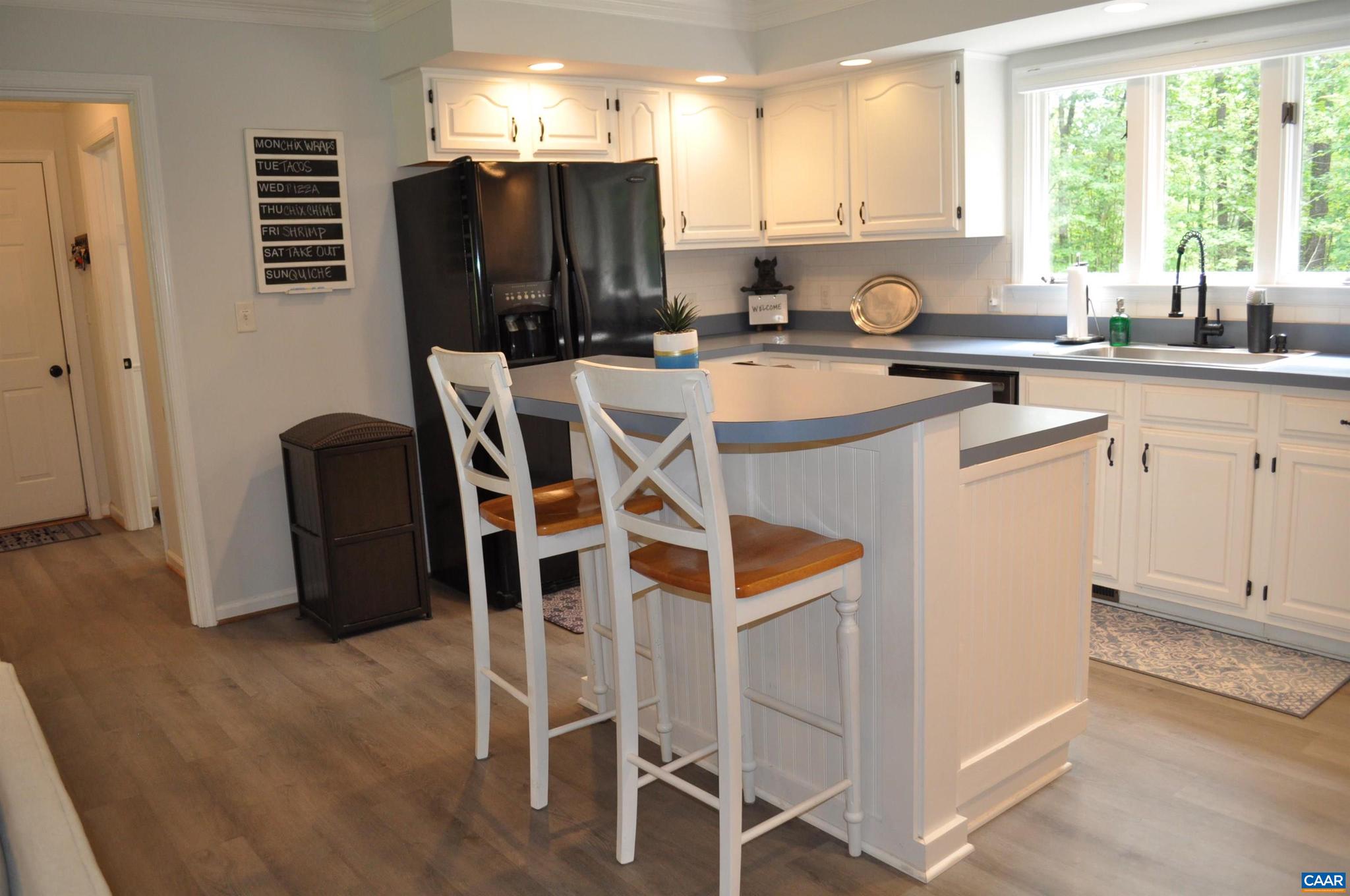 3257 Martin Kings Road Charlottesville, VA 22902 - Photo 15 of 49 a kitchen with a refrigerator a stove a sink and dishwasher with wooden floor