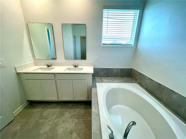 a bathroom with a bathtub and shower
