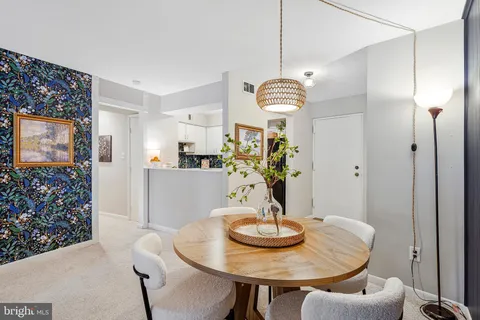 a view of a dining room with furniture and chandelier
