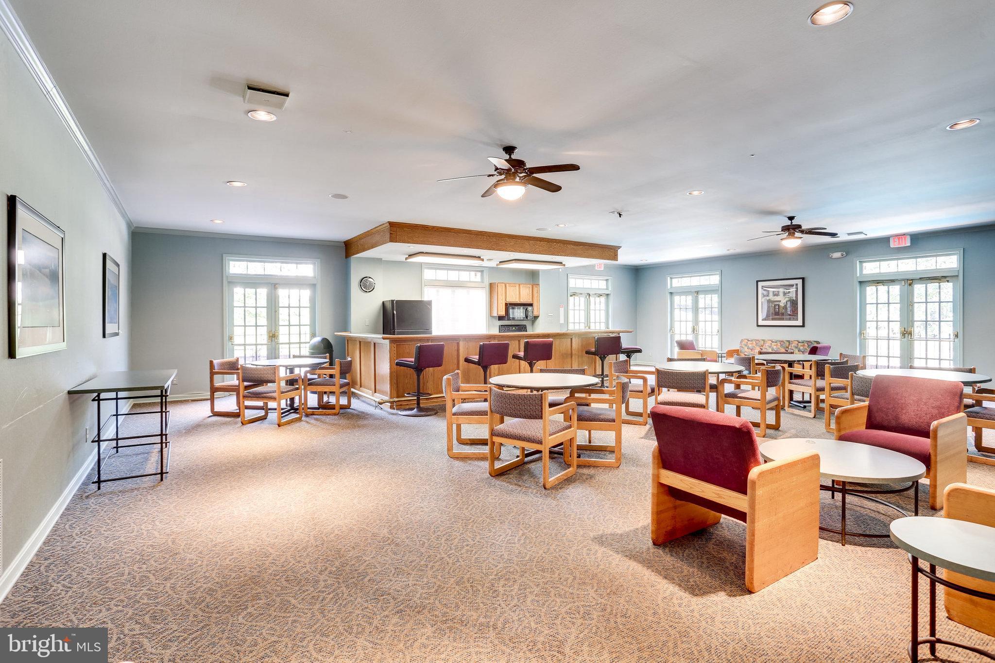 5778 Rexford Court, Unit 5778B Springfield, VA 22152 - Photo 36 of 55 a living room with furniture and a dining table with wooden floor