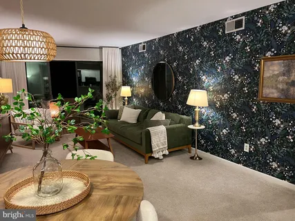 a living room with furniture and a potted plant