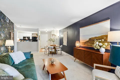 a living room with furniture and a dining table with rug kitchen