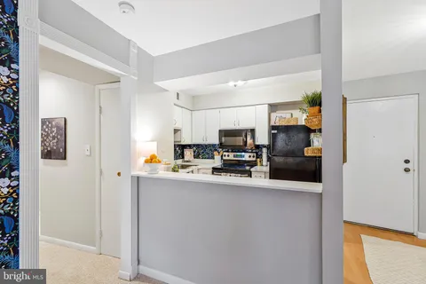 a view of kitchen with stainless steel appliances a refrigerator and a stove top oven