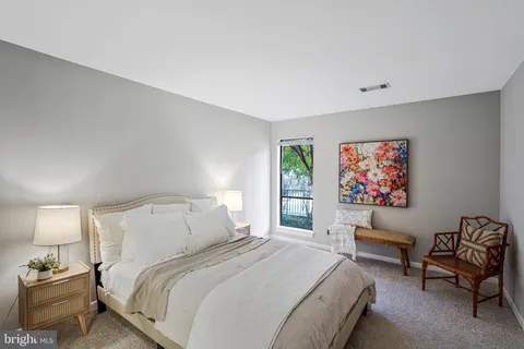 a bedroom with a bed and a couch