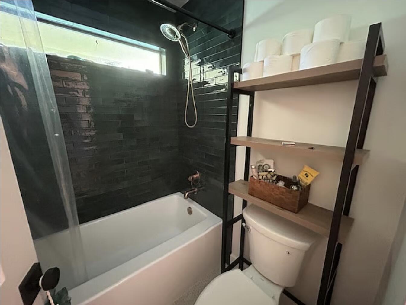 1822 Windsor Drive, Unit 1 Juno Ridge, FL 33408 - Photo 6 of 12 a bathroom with a bathtub toilet and a shower