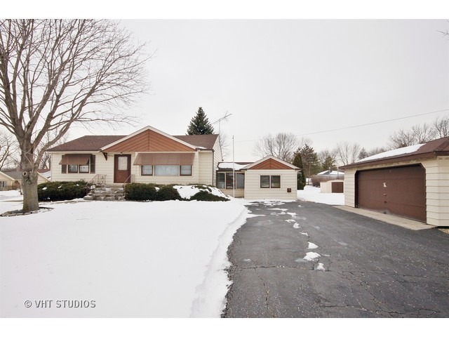 8450 Wolf Road Willow Springs, IL 60480 - Photo 1 of 10 a front view of a house with a yard covered in snow