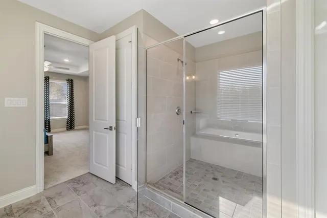 a bathroom with a glass shower door and a glass door