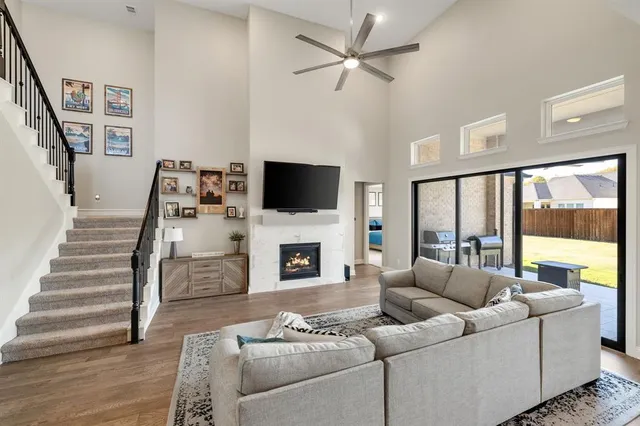 a living room with furniture a fireplace and a flat screen tv