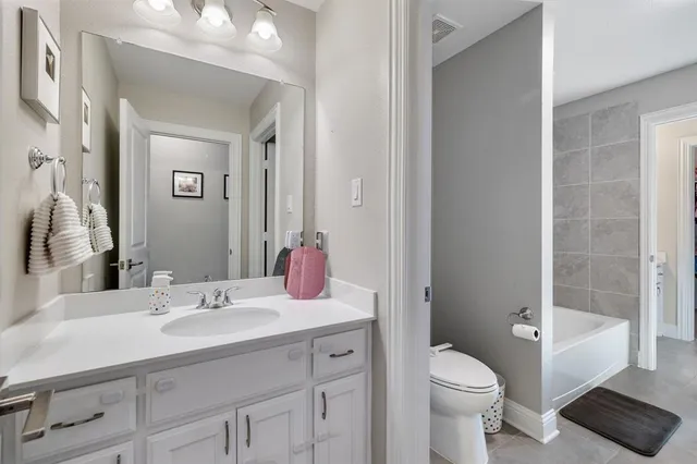 a bathroom with a sink toilet vanity and shower