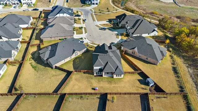 an aerial view of a house with a park