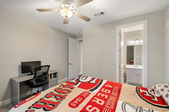 a bedroom with a bed and a television