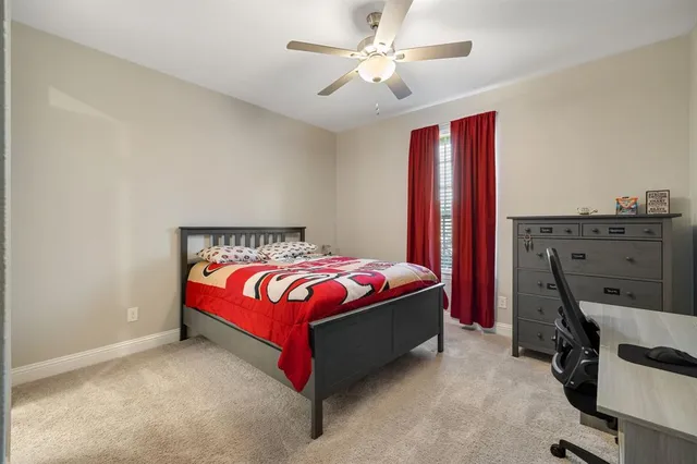 a spacious bedroom with a bed and a chandelier