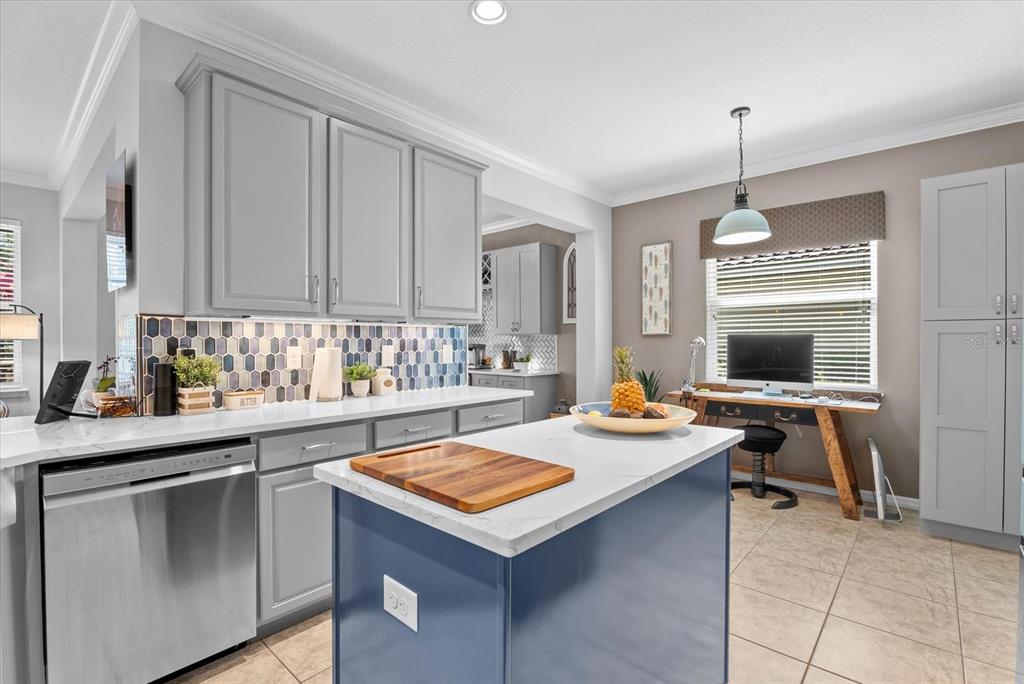 5439 Cartagena Drive Sarasota, FL 34233 - Photo 12 of 40 a kitchen with a sink a stove and chairs