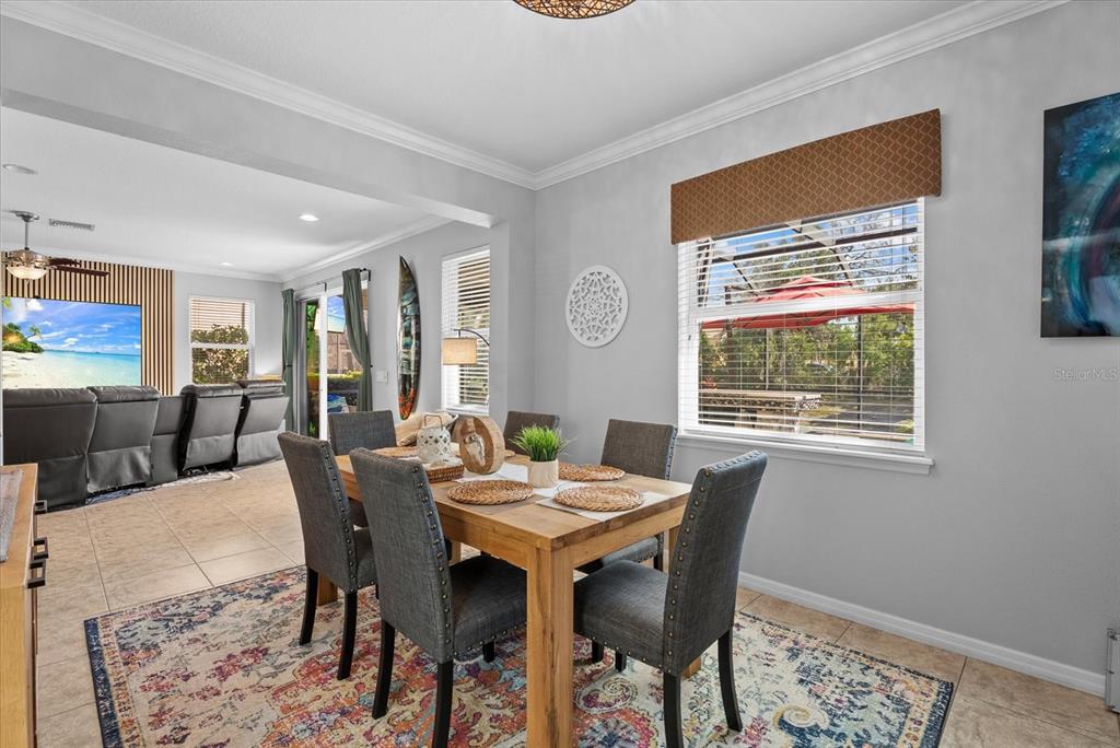 5439 Cartagena Drive Sarasota, FL 34233 - Photo 14 of 40 a view of a dining room with furniture window and wooden floor