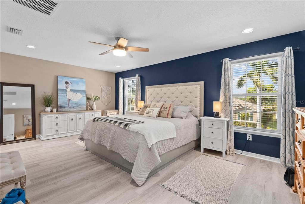 5439 Cartagena Drive Sarasota, FL 34233 - Photo 18 of 40 a spacious bedroom with a large bed and a chandelier