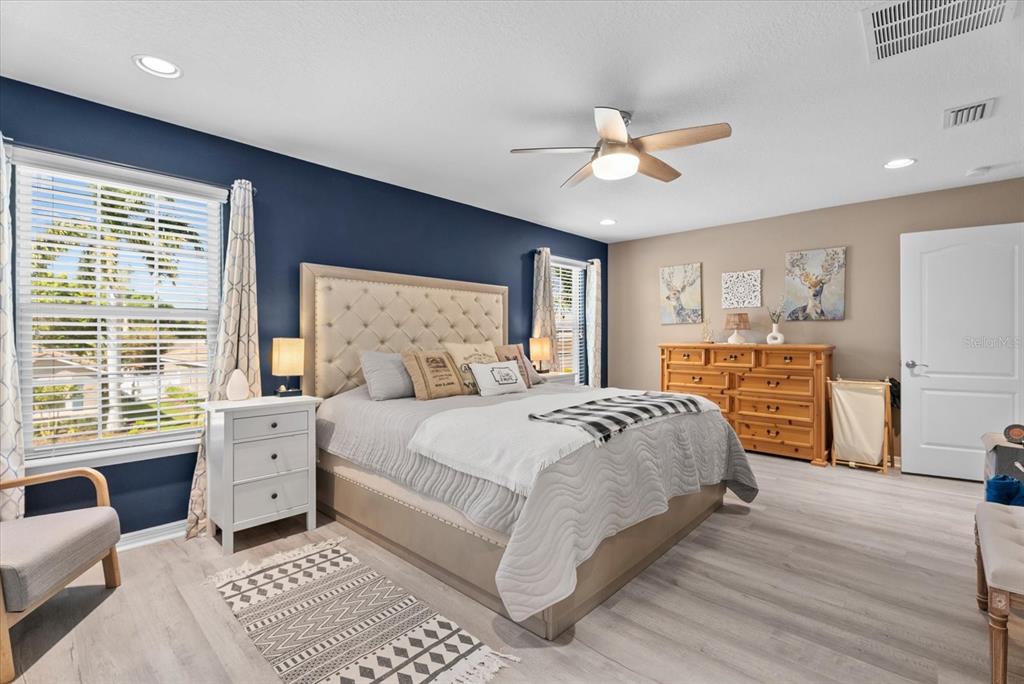 5439 Cartagena Drive Sarasota, FL 34233 - Photo 19 of 40 a spacious bedroom with a large bed and a chandelier