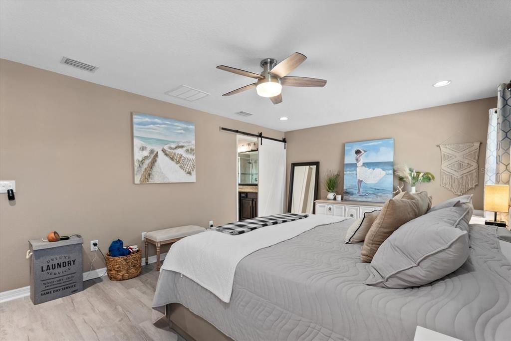 5439 Cartagena Drive Sarasota, FL 34233 - Photo 20 of 40 a bedroom with a bed and wooden floor