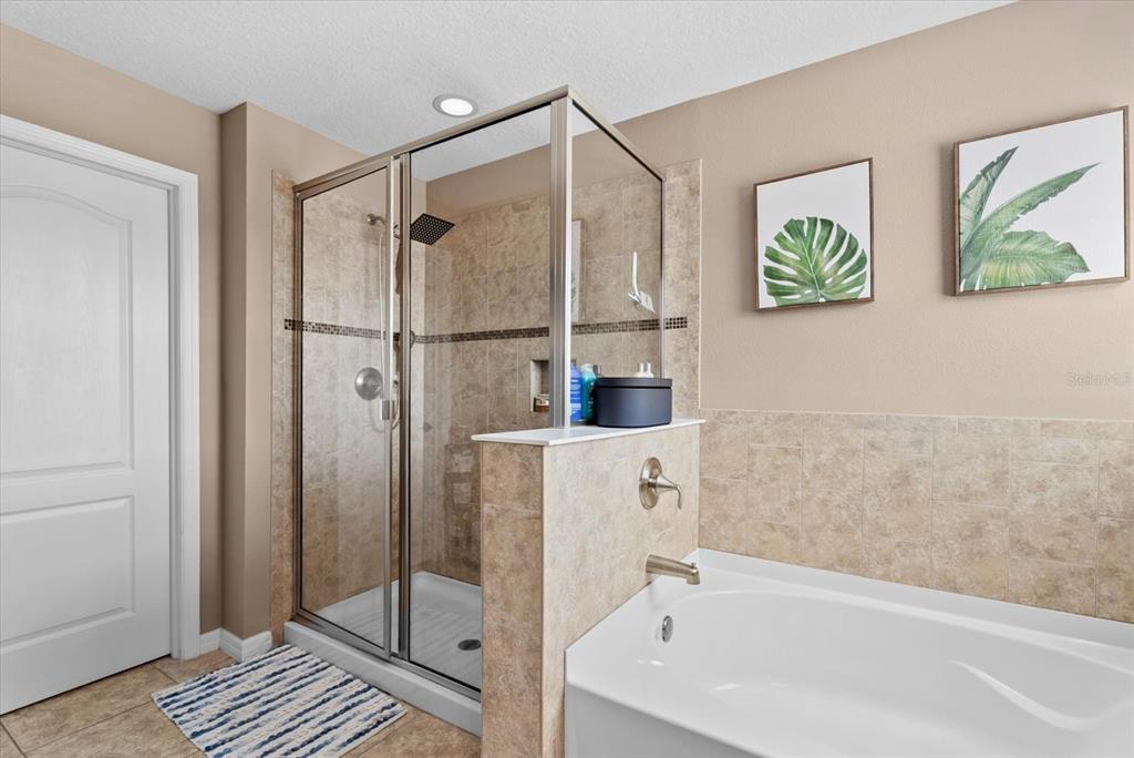 5439 Cartagena Drive Sarasota, FL 34233 - Photo 22 of 40 a bathroom with a bathtub and a shower
