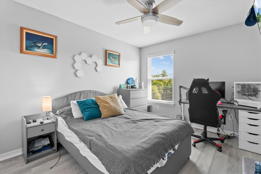 5439 Cartagena Drive Sarasota, FL 34233 - Photo 23 of 40 a bedroom with a bed and a desk