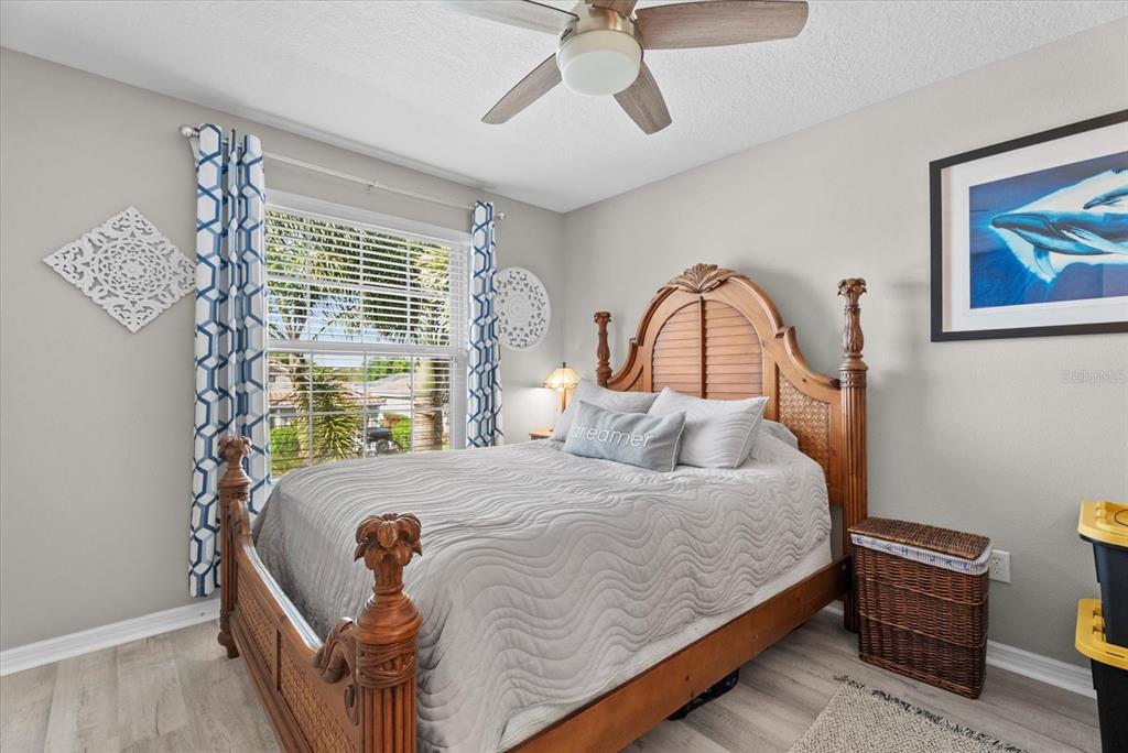 5439 Cartagena Drive Sarasota, FL 34233 - Photo 24 of 40 a bedroom with a bed wooden floor and window