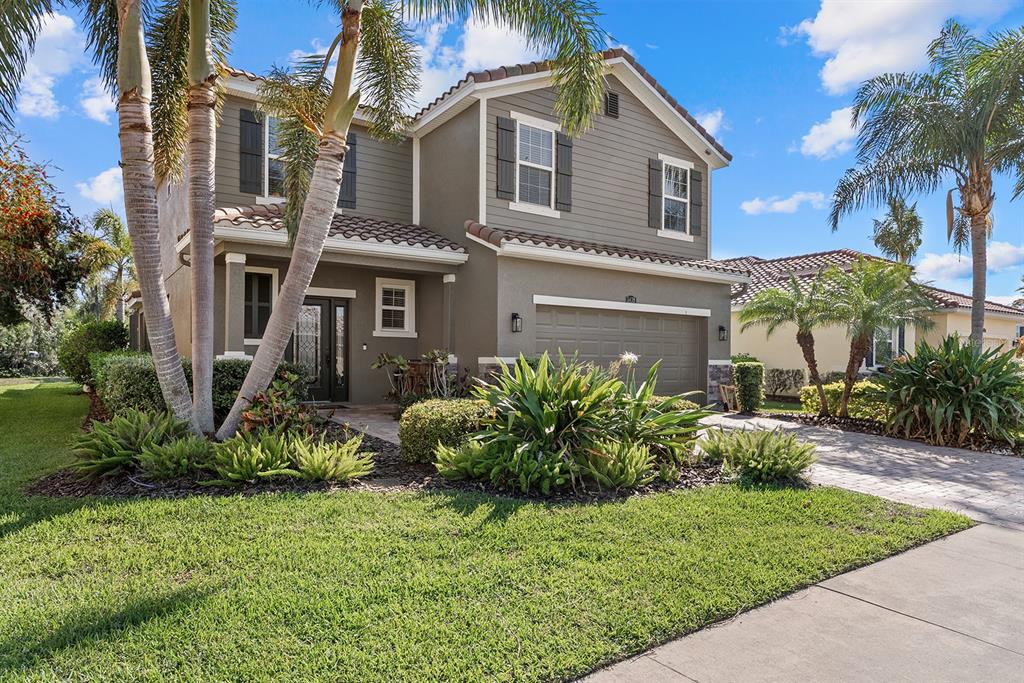 5439 Cartagena Drive Sarasota, FL 34233 - Photo 3 of 40 a front view of a house with a yard