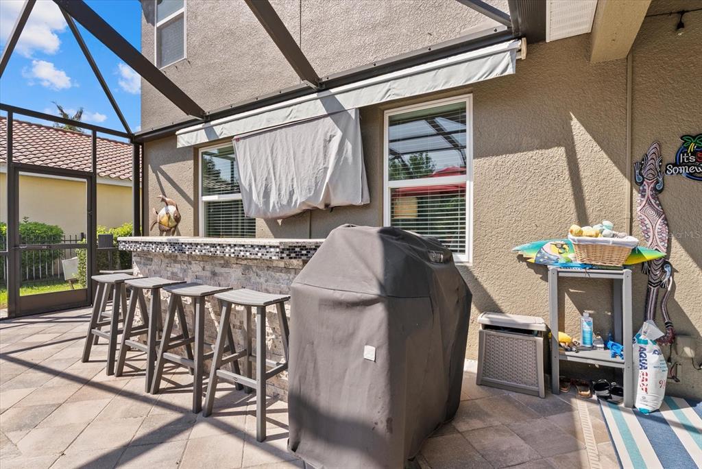 5439 Cartagena Drive Sarasota, FL 34233 - Photo 38 of 40 a view of a patio with table and chairs and potted plants