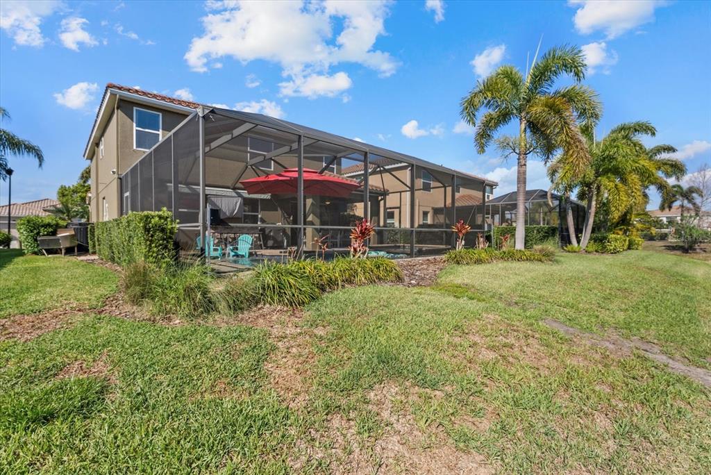 5439 Cartagena Drive Sarasota, FL 34233 - Photo 39 of 40 a view of a house with a big yard and a large tree