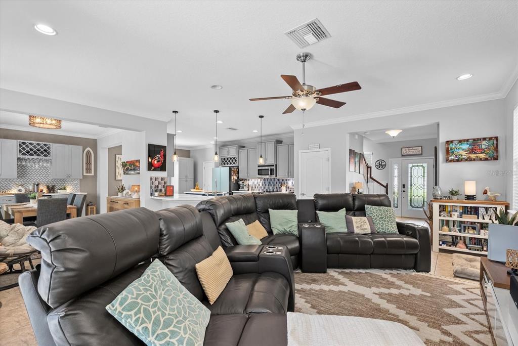 5439 Cartagena Drive Sarasota, FL 34233 - Photo 5 of 40 a living room with furniture and a ceiling fan