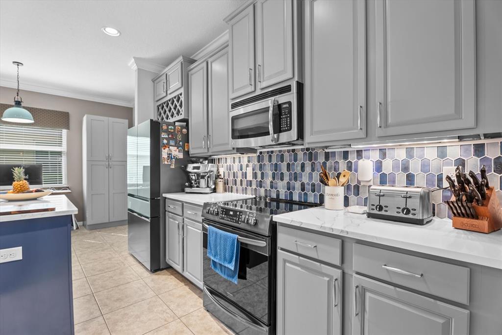 5439 Cartagena Drive Sarasota, FL 34233 - Photo 8 of 40 a kitchen with stainless steel appliances granite countertop a stove a sink and a refrigerator