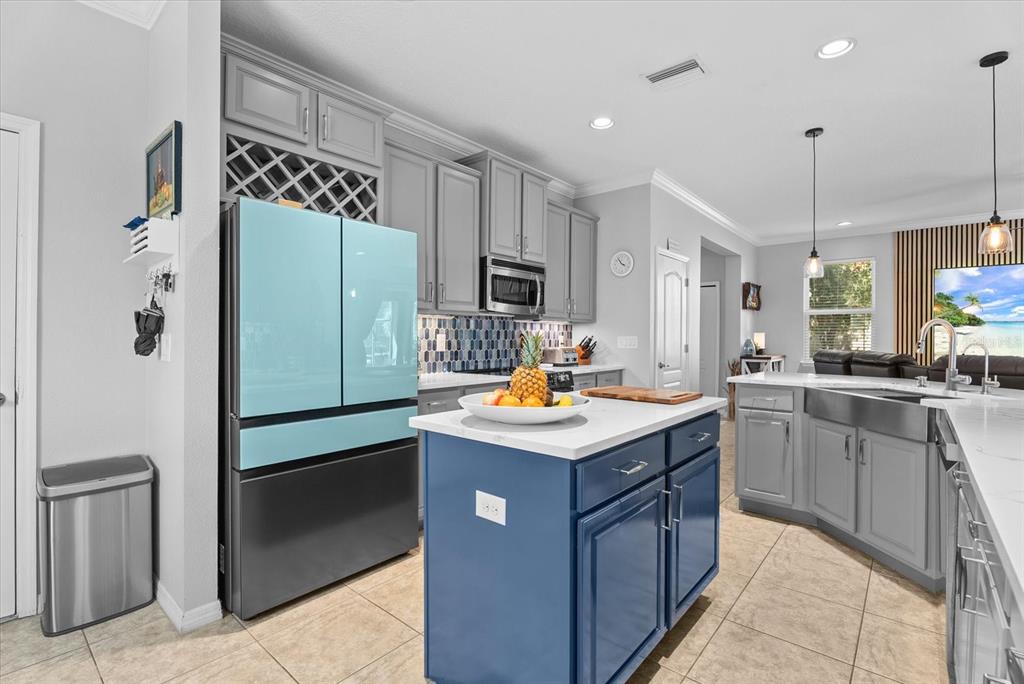 5439 Cartagena Drive Sarasota, FL 34233 - Photo 10 of 40 a kitchen with a sink a refrigerator and cabinets