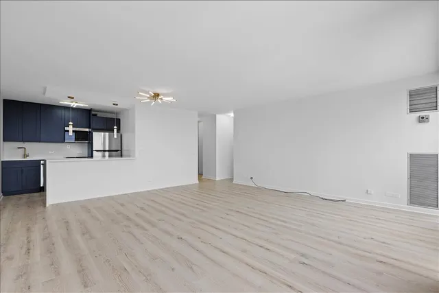 a view of a kitchen with microwave and cabinets