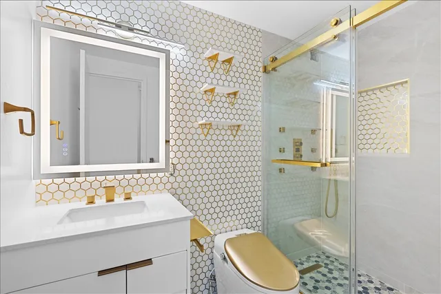 a bathroom with a sink a toilet and shower