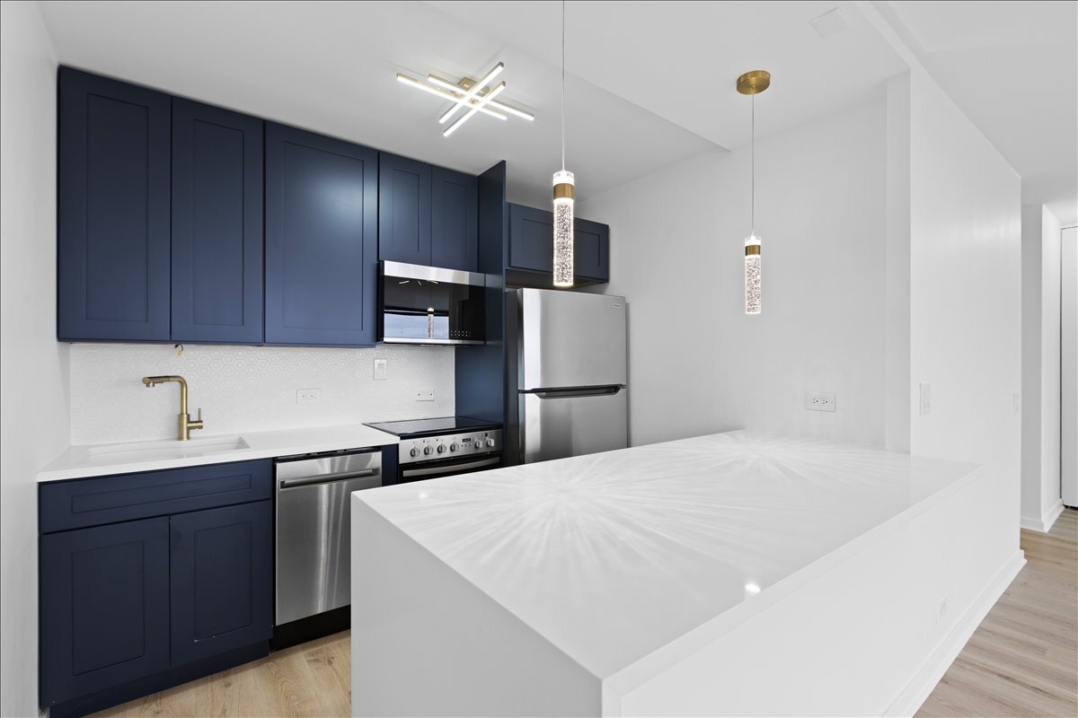 4343 North Clarendon Avenue, Unit 2507 Chicago, IL 60613 - Photo 2 of 23 a kitchen with a sink a refrigerator and cabinets