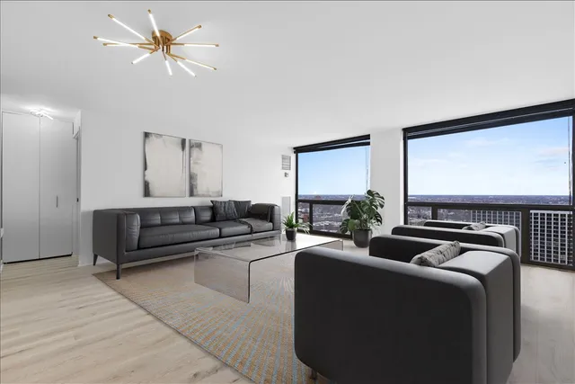 a living room with furniture ceiling fan and a rug