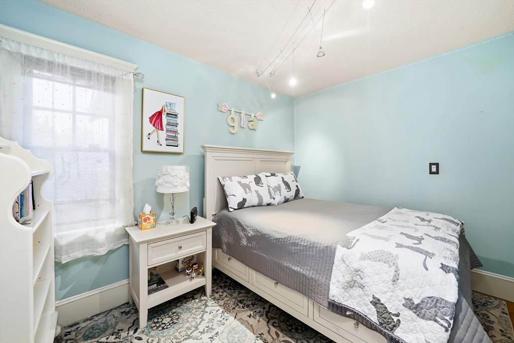 4 Wescott Road Stoneham, MA 02180 - Photo 11 of 42 a bedroom with a bed and a window